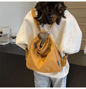 Rear view of model wearing a mustard yellow multi-pocket canvas backpack for daily commute