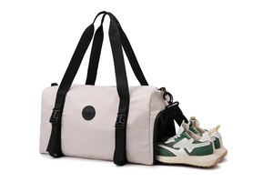 Detail of the specialized shoe compartment in a beige waterproof travel fitness bag