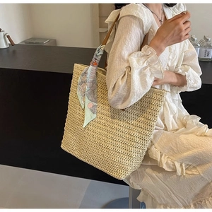 Large beige woven straw tote bag for women featuring decorative floral silk scarf