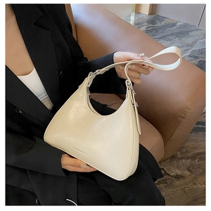 Detail of cream white half-moon underarm bag with silver hardware and fashion text logo