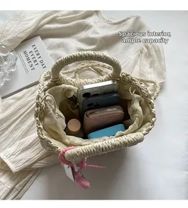 Internal view of beige woven straw tote showing large capacity for phone and wallet