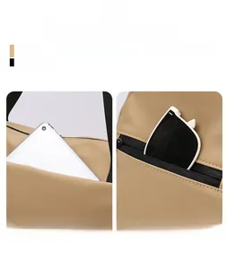 Detail view of khaki travel bag showing front tablet pocket and side sunglasses zip pouch