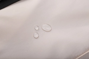 Close-up of waterproof Oxford fabric with water droplets showing splash resistance