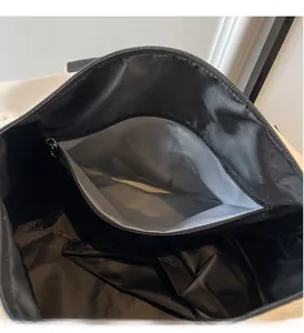 Close-up of waterproof dry wet separation compartment inside the black sports bag
