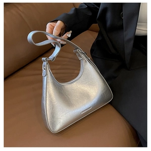 Close-up of metallic silver hobo bag with crinkled texture and FASHION & BAG detail