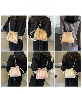 Quilted bucket bag with chain strap shown in various colors and styling on a model