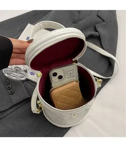 White quilted cylinder crossbody bag interior with phone and wallet storage space