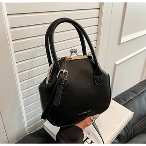 Detail of black faux leather doctor bag showing metal frame closure and logo