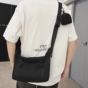 Versatile black canvas tote bag with crossbody strap and small detachable coin purse