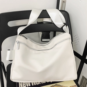 Minimalist beige tote bag with wide shoulder strap displayed on a chair for daily use