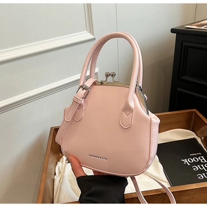 Detail of light pink doctor bag with metal clasp and Fashion & Bag embossed text