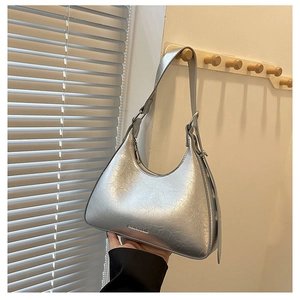 Close-up of silver hobo bag with vintage cracked texture and adjustable strap detail