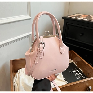 Detail of light pink vintage doctor bag with silver metal clasp and top handles