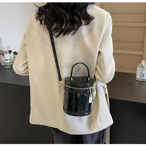 Detailed back view of a black quilted leather bucket bag with a golden zipper and padlock