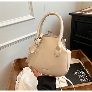 Detail of cream white vintage doctor bag with fashion lettering and metal clasp closure