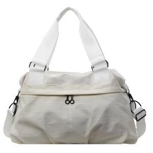 Cream white nylon tote bag with wide shoulder strap and dual top handles for travel