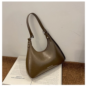 Detail of vintage brown shoulder bag with textured faux leather and metal ring buckles