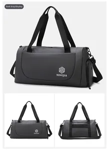 Detail view of dark grey waterproof fitness travel bag with shoulder strap and zipper pockets