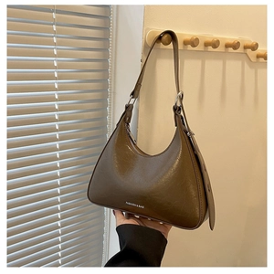 Detailed close-up of dark brown vintage texture underarm bag with silver ring hardware