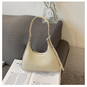 Close-up of the elegant cream PU leather texture and silver buckle on this hobo bag