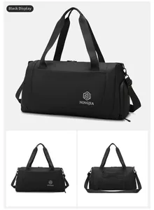 Detail of a black large capacity travel bag with durable straps and side pockets