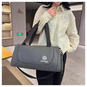 Detail of grey travel duffel bag with durable shoulder strap and large capacity