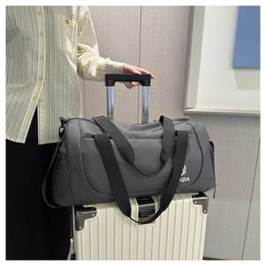 Detail of grey travel bag featuring a trolley sleeve for securing on suitcase luggage