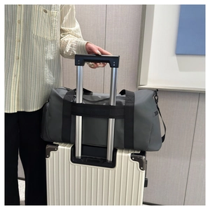Detail of travel duffel bag showing the trolley sleeve attached to luggage handle
