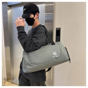 Man carrying a large grey travel bag with NINGJIA logo during city commute in an elevator