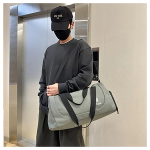 Gray-green waterproof nylon gym bag with adjustable shoulder strap and side zipper pocket