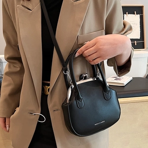 Classic black leather doctor bag featuring a silver metal clasp and crossbody strap