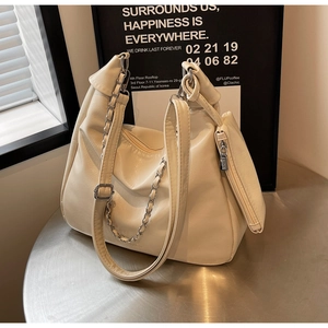 Detail of off-white PU leather tote bag with silver chain and mini zipper pouch