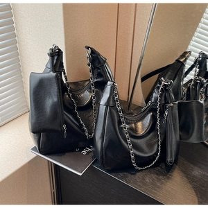 Detail of black glossy Hobo bag with chain strap and matching detachable coin pouch