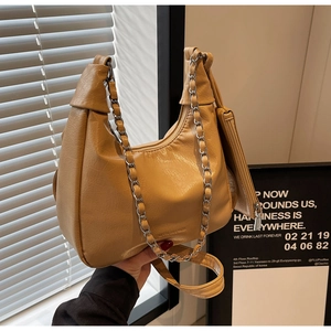 Detail of hobo bag with silver chain, leather strap and detachable coin purse