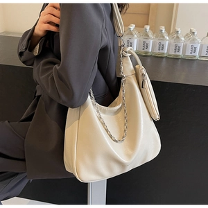Detail of cream hobo tote bag with silver chain strap and matching small coin purse
