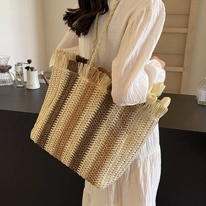Large striped straw tote bag with tassel trim for summer beach vacation shoulder carry