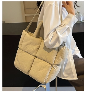 Detail of beige quilted puffer tote bag with large square weave texture and side view