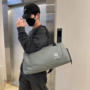 Large gray-green waterproof duffle bag with shoulder strap for gym, travel, and sports