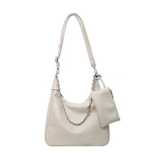 Beige tote bag with silver chain and detachable coin purse on white background