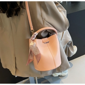 Detail of pink lychee leather bucket bag with Chio2nd logo and silk scarf decoration