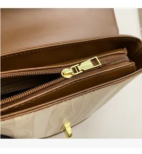 Detail of smooth gold metal zipper and wavy textured leather on vintage bucket bag