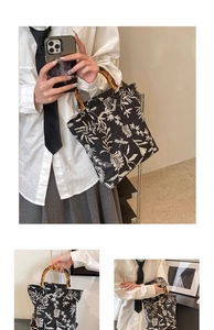 Détails de broderie de feuilles et poignée en bambou sur le sac cabas en toile
