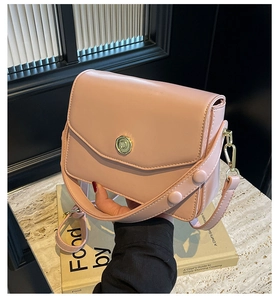 Detail of pink leather flap square bag with gold C-clasp hardware and wide strap