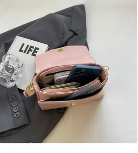 Pink PU leather crossbody bag with magnetic flap and multi-compartment interior storage