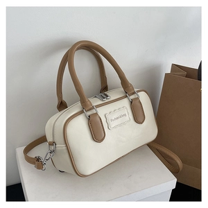 Detail of cream and brown two-tone mini box bag with fashion lettering and silver zipper