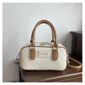 Close-up of a mini Boston bag in cream and brown PU leather with Fashion&bag logo