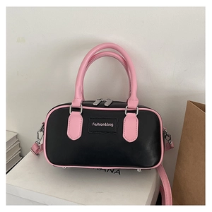 Mini Boston bag detail with black faux leather and bright pink top handles