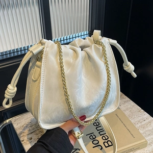 White pleated bucket bag with golden chain strap and drawstring closure for women