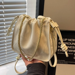 Modern creamy white ruched bucket bag with gold chain strap and drawstring details