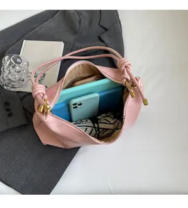 Spacious interior of pink leather tote bag showing storage for phone and umbrella